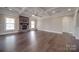 Spacious living room featuring hardwood floors and a stone fireplace at 10881 Greenvale Dr, Harrisburg, NC 28075