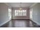 Bright dining room with hardwood floors and large windows at 10881 Greenvale Dr, Harrisburg, NC 28075