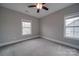 Bedroom with carpet flooring, ceiling fan and two windows at 10881 Greenvale Dr, Harrisburg, NC 28075