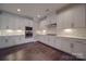 Modern kitchen with white cabinets, quartz countertops, and stainless steel appliances at 10881 Greenvale Dr, Harrisburg, NC 28075