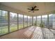 Spacious screened porch with wood flooring and views of backyard at 10881 Greenvale Dr, Harrisburg, NC 28075