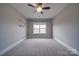 Bedroom with carpet flooring, ceiling fan and window at 10881 Greenvale Dr, Harrisburg, NC 28075