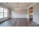 Elegant dining room with hardwood floors, wainscoting and chandelier at 10881 Greenvale Dr, Harrisburg, NC 28075