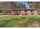 Brick ranch home with landscaped yard and attached carport at 137 Brady Ln, Statesville, NC 28625