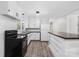 Modern kitchen with white cabinets, an island with butcher block top, and black appliances at 137 Brady Ln, Statesville, NC 28625