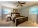 Spacious bedroom with large bed, two windows, and ceiling fan at 204 Suburban Ave, Kannapolis, NC 28083