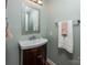 Clean and modern bathroom with a single vanity and decorative mirror at 326 Thistle Ln, Statesville, NC 28625