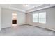 Spacious bedroom with neutral carpeting and en-suite bathroom access at 14905 Tamarack Dr, Charlotte, NC 28278