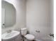 Simple, clean bathroom with pedestal sink and octagon mirror at 14905 Tamarack Dr, Charlotte, NC 28278