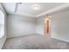 Bright bedroom featuring neutral walls, carpet flooring, and a window with blinds at 14905 Tamarack Dr, Charlotte, NC 28278