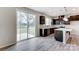 Eat in kitchen with island, dark cabinets, and sliding glass door to patio at 14905 Tamarack Dr, Charlotte, NC 28278