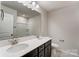 Bathroom with double vanity, mirror, and a shower/tub combo at 14905 Tamarack Dr, Charlotte, NC 28278