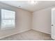 Simple bedroom with neutral walls, carpet, and a window with blinds at 14905 Tamarack Dr, Charlotte, NC 28278