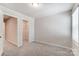 Bedroom with neutral walls, carpet flooring, a window with blinds and closet at 14905 Tamarack Dr, Charlotte, NC 28278