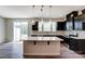Open kitchen with island, stainless steel appliances and access to backyard at 14905 Tamarack Dr, Charlotte, NC 28278