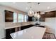 Modern kitchen with dark cabinetry, quartz countertops, and stainless steel appliances at 14905 Tamarack Dr, Charlotte, NC 28278