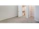 Bedroom with carpet flooring, access to a shared bathroom, and a walk-in closet at 14905 Tamarack Dr, Charlotte, NC 28278