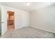 Bedroom with carpet, access to upstairs hallway and staircase at 14901 Tamarack Dr, Charlotte, NC 28278