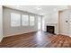 Bright Gathering room featuring a fireplace and hardwood floors at 14901 Tamarack Dr, Charlotte, NC 28278