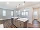 Modern kitchen island with white quartz countertops and stainless steel appliances at 14901 Tamarack Dr, Charlotte, NC 28278