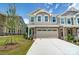 Townhouse with two-car garage, stone accents and landscaping at 14901 Tamarack Dr, Charlotte, NC 28278