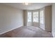 Bright bedroom with bay window and neutral carpeting at 8614 Sawleaf Ct, Charlotte, NC 28215