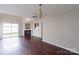 Spacious living room featuring hardwood floors, a fireplace, and access to a backyard patio at 8614 Sawleaf Ct, Charlotte, NC 28215