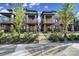 Three-story townhouses with brick and wood exteriors, landscaped yards, and welcoming porches at 339 East Blvd, Charlotte, NC 28203