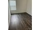 Spacious bedroom with dark brown wood-look flooring and a window with blinds at 929 Roxburgh Ave # 51, Rock Hill, SC 29732