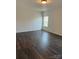 Bright bedroom featuring dark brown wood-look flooring and a window with blinds at 929 Roxburgh Ave # 51, Rock Hill, SC 29732