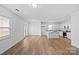 Open living space with kitchen island and hardwood floors at 5006 Sunbriar Dr # 001, Charlotte, NC 28216