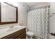 Bathroom with shower/tub combo, vanity, and patterned curtain at 7006 Garden Hill Dr, Huntersville, NC 28078
