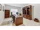 Bright home office features built-in shelving and a large desk at 7006 Garden Hill Dr, Huntersville, NC 28078