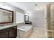 Primary bathroom with soaking tub, double vanity, and walk-in shower at 7006 Garden Hill Dr, Huntersville, NC 28078