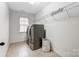 Laundry room with washer, dryer, and overhead shelving at 7006 Garden Hill Dr, Huntersville, NC 28078