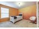 Bright bedroom with orange walls, white bed frame, and accent chair at 7006 Garden Hill Dr, Huntersville, NC 28078