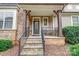 Inviting front porch with stone accents and a charming entrance at 7006 Garden Hill Dr, Huntersville, NC 28078