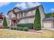Two-story house with stone and beige siding at 7006 Garden Hill Dr, Huntersville, NC 28078