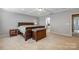 Spacious bedroom with carpeted floor, wooden bed frame and nightstand at 7006 Garden Hill Dr, Huntersville, NC 28078
