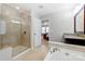 Spa-like bathroom with walk-in shower, soaking tub, and separate vanities at 7006 Garden Hill Dr, Huntersville, NC 28078