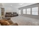 Finished basement with seating area and plenty of natural light at 7006 Garden Hill Dr, Huntersville, NC 28078