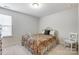 Bedroom with a floral bedspread, window, and a white chair at 7006 Garden Hill Dr, Huntersville, NC 28078