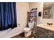Small bathroom with toilet, sink, and storage shelving at 831 College Ave, Shelby, NC 28152