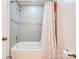 Bathtub with tiled surround and colorful shower curtain at 831 College Ave, Shelby, NC 28152