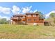 Two-story home with wood siding, deck, and large backyard at 831 College Ave, Shelby, NC 28152