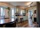 Open concept kitchen with teal cabinets, stainless steel appliances, and a breakfast nook at 831 College Ave, Shelby, NC 28152