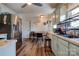 Kitchen boasts light teal cabinets, stainless steel appliances, and wood flooring at 831 College Ave, Shelby, NC 28152