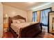Bedroom with wooden bed frame and floor-length curtains at 831 College Ave, Shelby, NC 28152