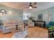 Living room with hardwood floors, ceiling fan, and comfortable seating at 831 College Ave, Shelby, NC 28152