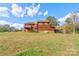 Two-story home with wood siding, deck, and large backyard at 831 College Ave, Shelby, NC 28152